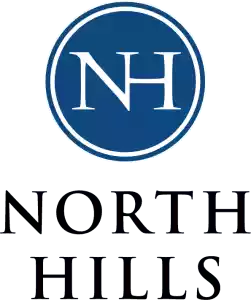 Logo of North Hills with dark blue circle and white
